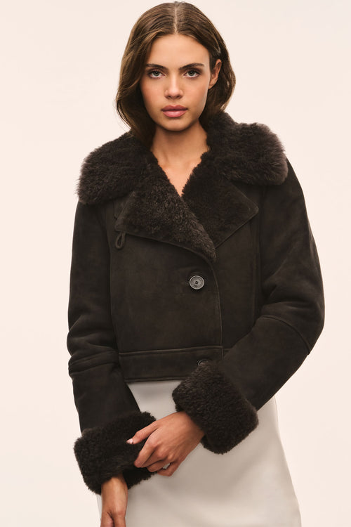 Cropped dark shearling jacket with wide fur collar and button-down placket