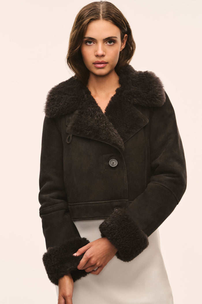 Cropped dark shearling jacket with wide fur collar and button-down placket