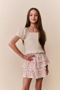 Light pink floral tiered ruffle skirt with layered tiers, angled view