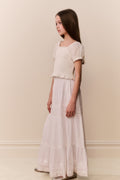 White cotton tiered maxi skirt in A-line silhouette with layered tiers