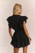 Black backless-style mini dress with tiered ruffle skirt and flutter sleeves