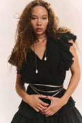 Black V-neck mini dress with ruffled shoulders, tiered skirt, and fitted elastic waist