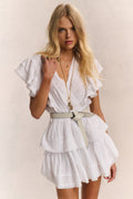 White tiered mini dress with V-neck and flutter ruffle sleeves, cinched waist
