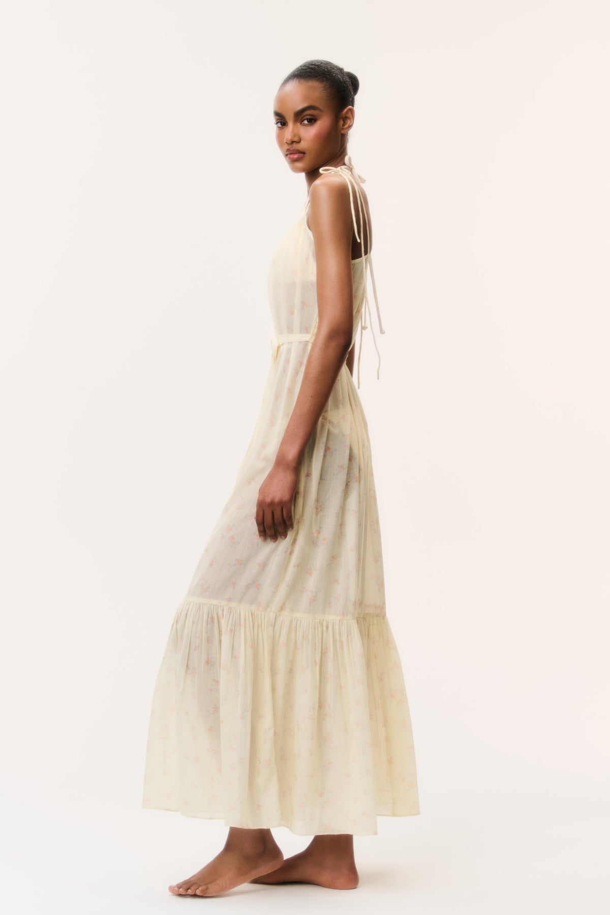 Light yellow cotton cover-up dress side view with spaghetti straps and tiered hem