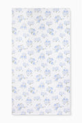 Hali beach towel in blue with all-over floral print, laid flat