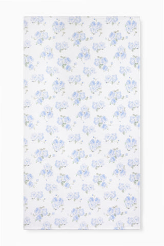 Hali beach towel in blue with all-over floral print, laid flat