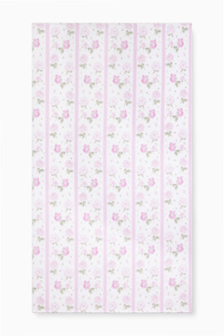 Hali beach towel in pretty pink with vertical stripes and floral print, laid flat
