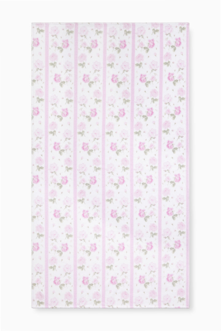 Hali beach towel in pretty pink with vertical stripes and floral print, laid flat