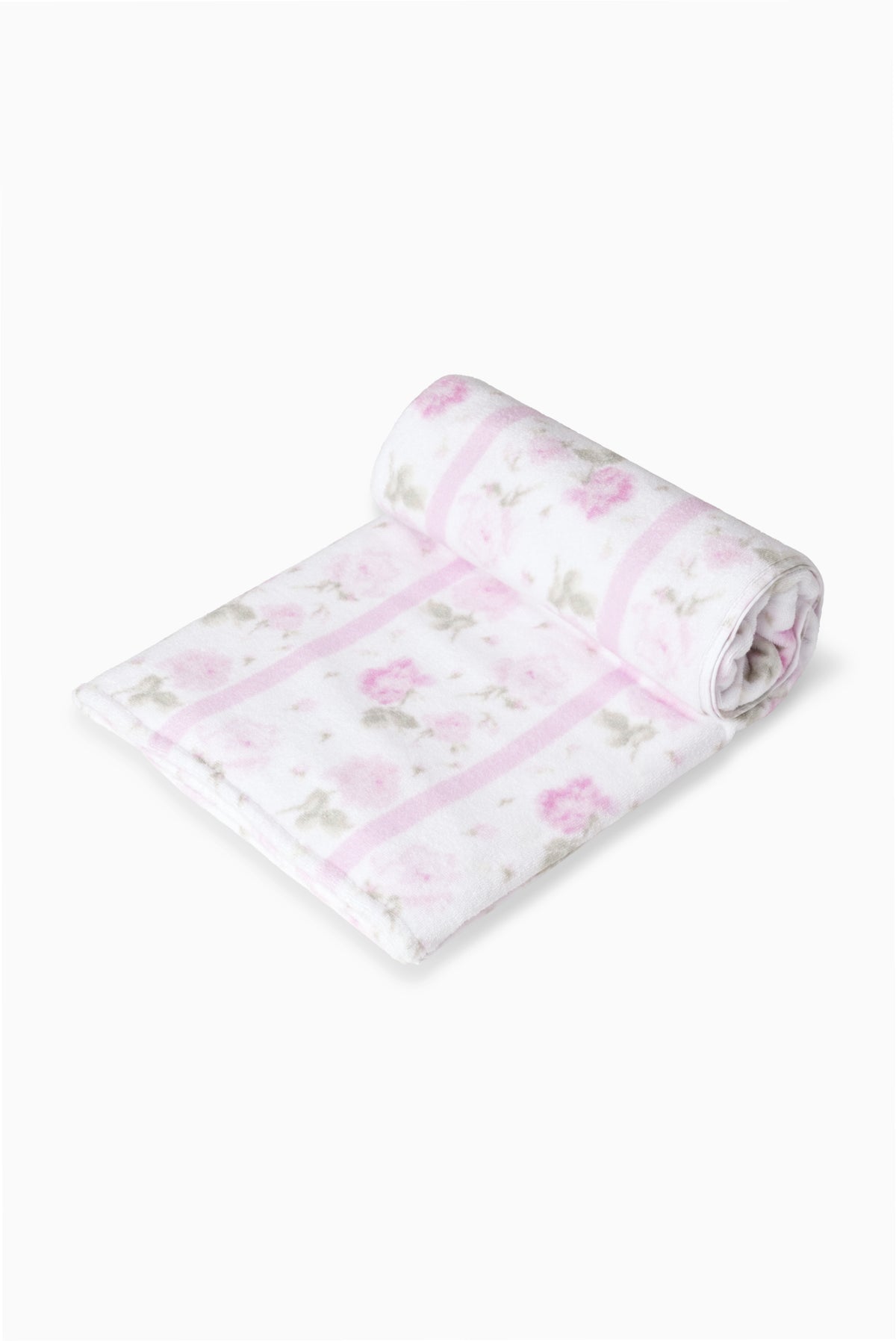 Hali beach towel in pretty pink with floral print, rolled with a stripe