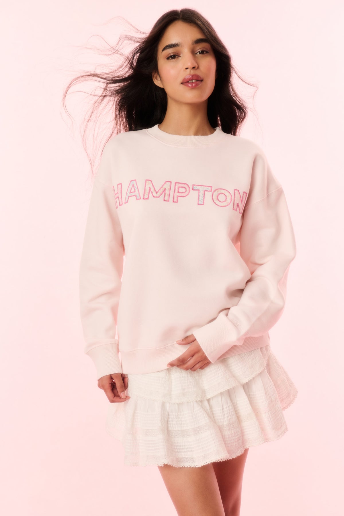 Light pink crewneck pullover sweatshirt with “HAMPTON” logo graphic on front