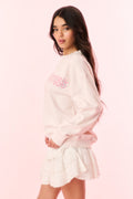 Light pink crewneck pullover sweatshirt with “ONS” pink graphic on front