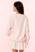 Light pink crewneck pullover sweatshirt with plain back and ribbed cuffs