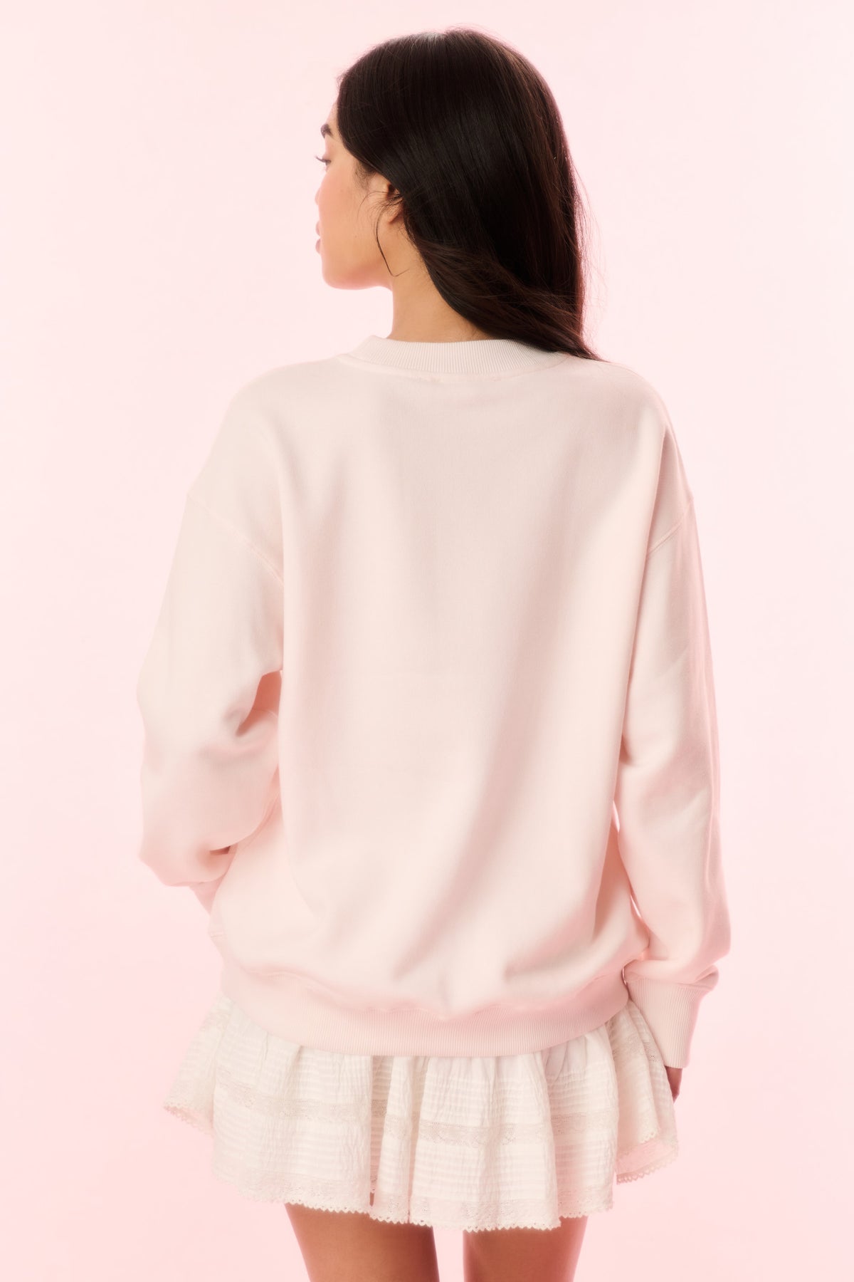 Light pink crewneck pullover sweatshirt with plain back and ribbed cuffs