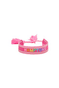 Pink woven bracelet with tassel ends and HAMPTONS lettering