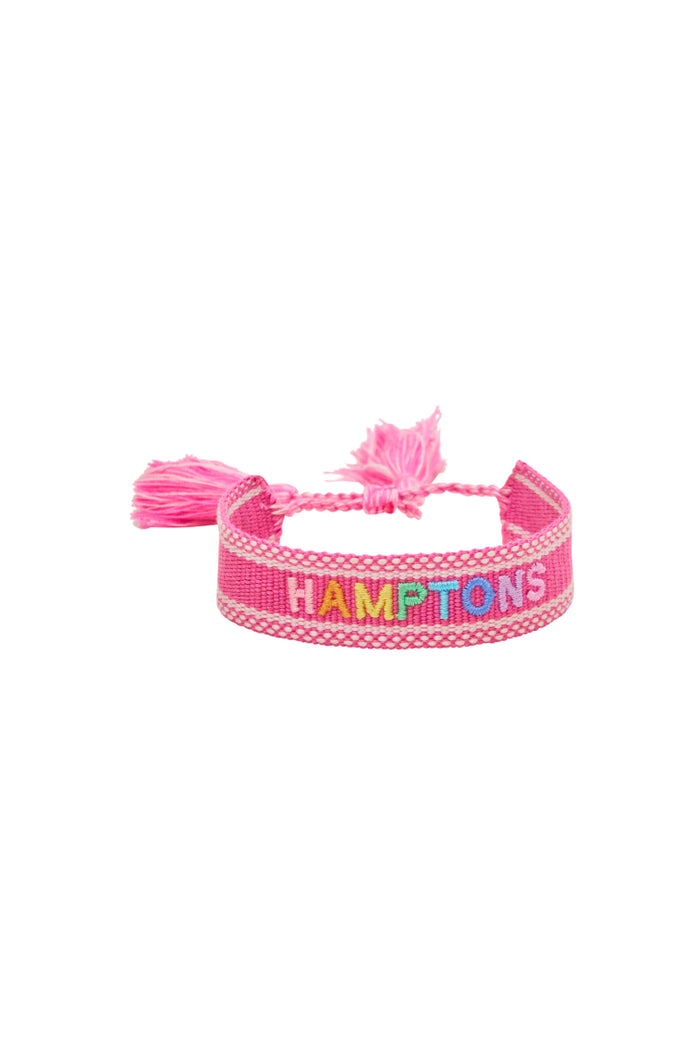 Pink woven bracelet with tassel ends and HAMPTONS lettering