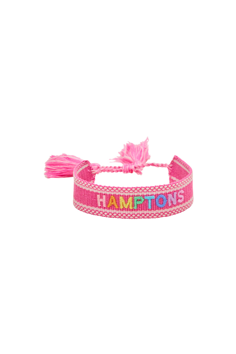 Pink woven bracelet with tassel ends and HAMPTONS lettering