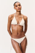 Cream ditsy floral bikini set with triangle halter top and side-tie bikini bottoms, front