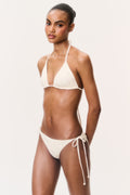 Cream ditsy floral triangle bikini with side-tie bikini bottoms, model standing pose