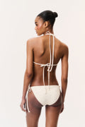 Back view of cream ditsy floral bikini set with crisscross halter straps and side ties