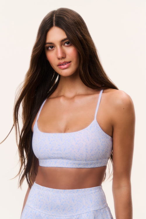 Light blue tennis-print sports bra with thin straps and supportive scoop front