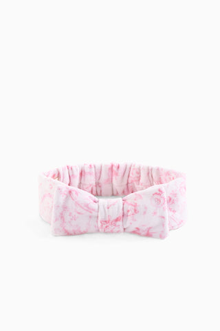 Pink patterned bow headband with gathered ruffle and stitched fabric bow
