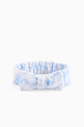 Blue floral bow headband with gathered ruffle and centered fabric knot