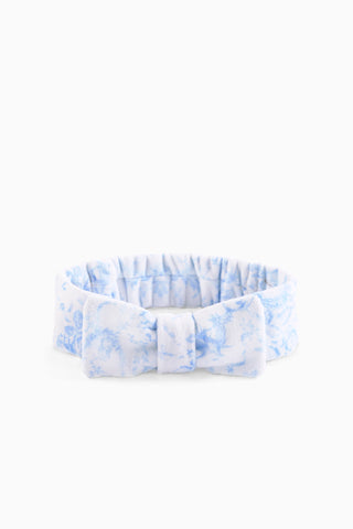 Blue floral bow headband with gathered ruffle and centered fabric knot