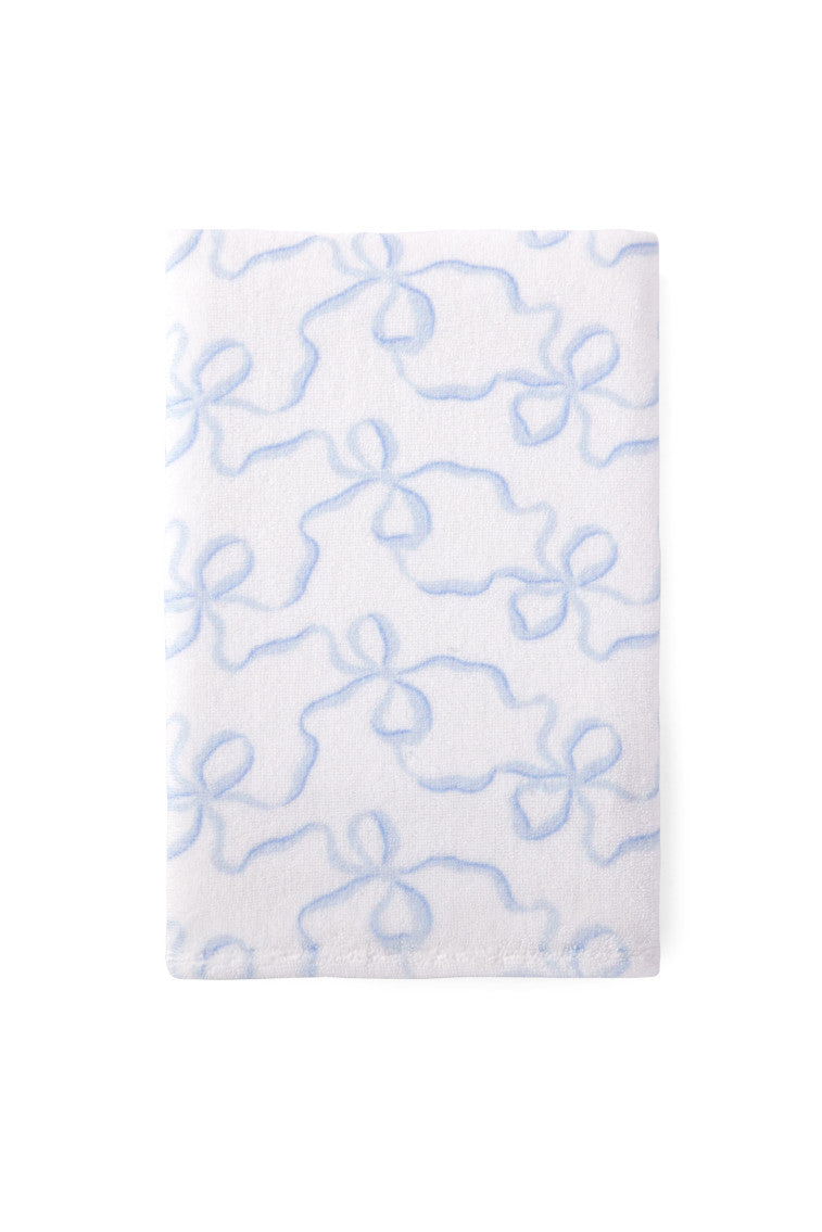 Light blue cotton hand towel with bow-like pattern, close-up