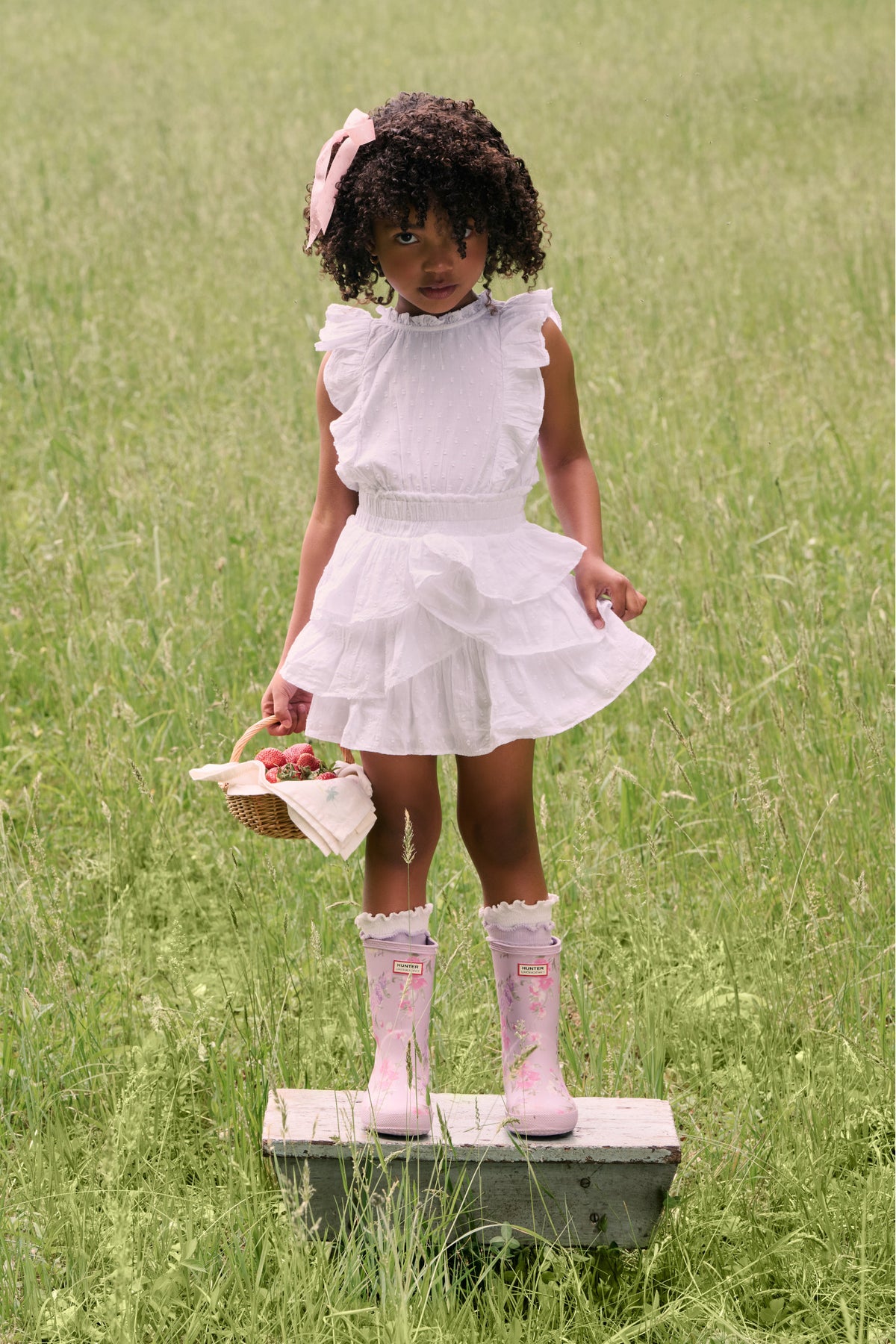 Kids classic rain boots in light pink with floral print and ruffled cuffs