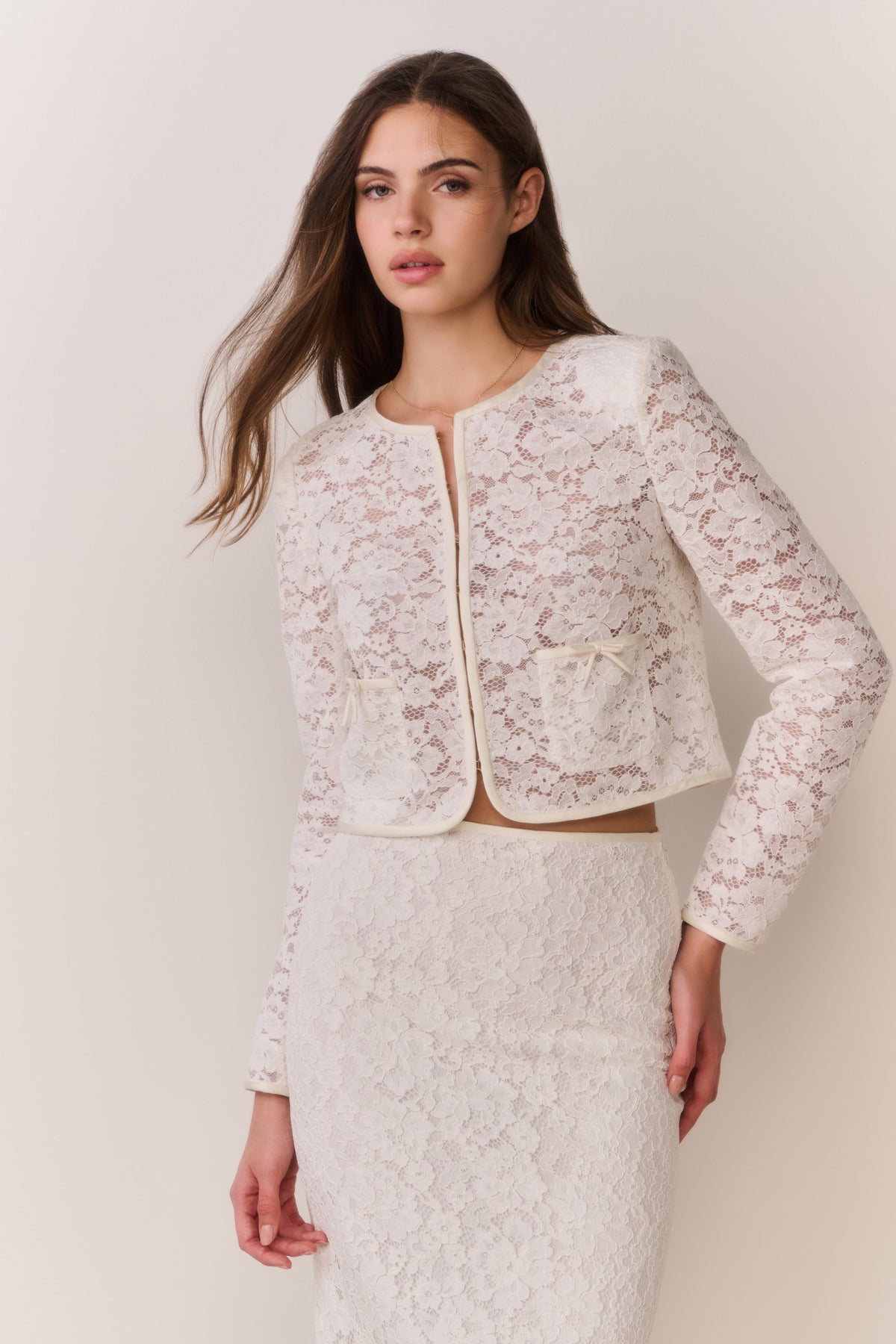 Ivory lace cropped jacket with long sleeves and front zipper detail