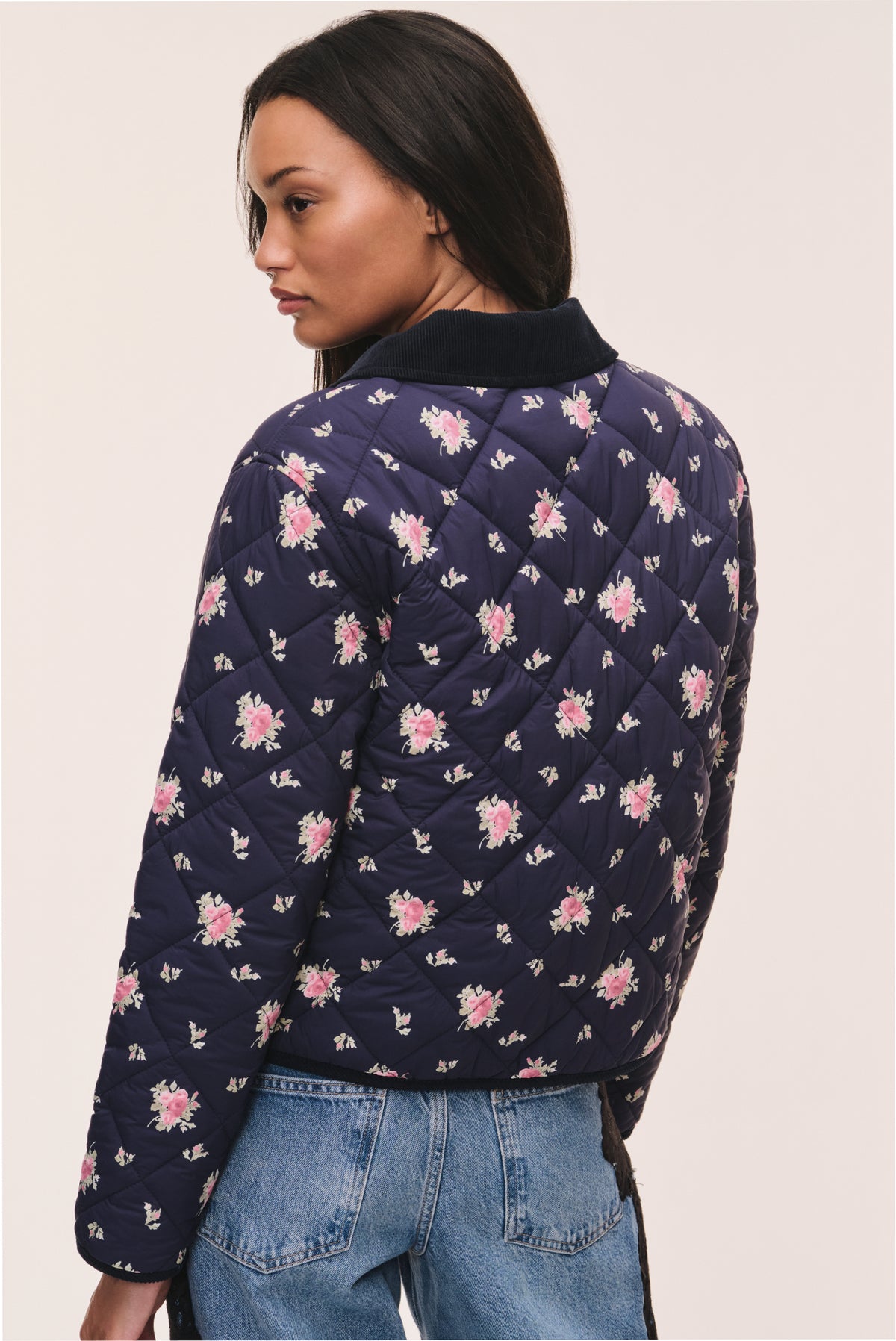 Dark navy floral quilted jacket with all-over pink flower pattern, back view