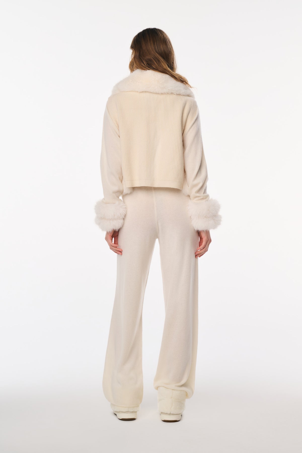 Ivory faux fur vest back view with cropped length and plush fur edging