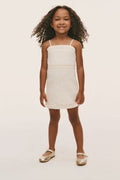 Ivory mini girls dress with spaghetti straps, seam at waist, eyelet-trim hem