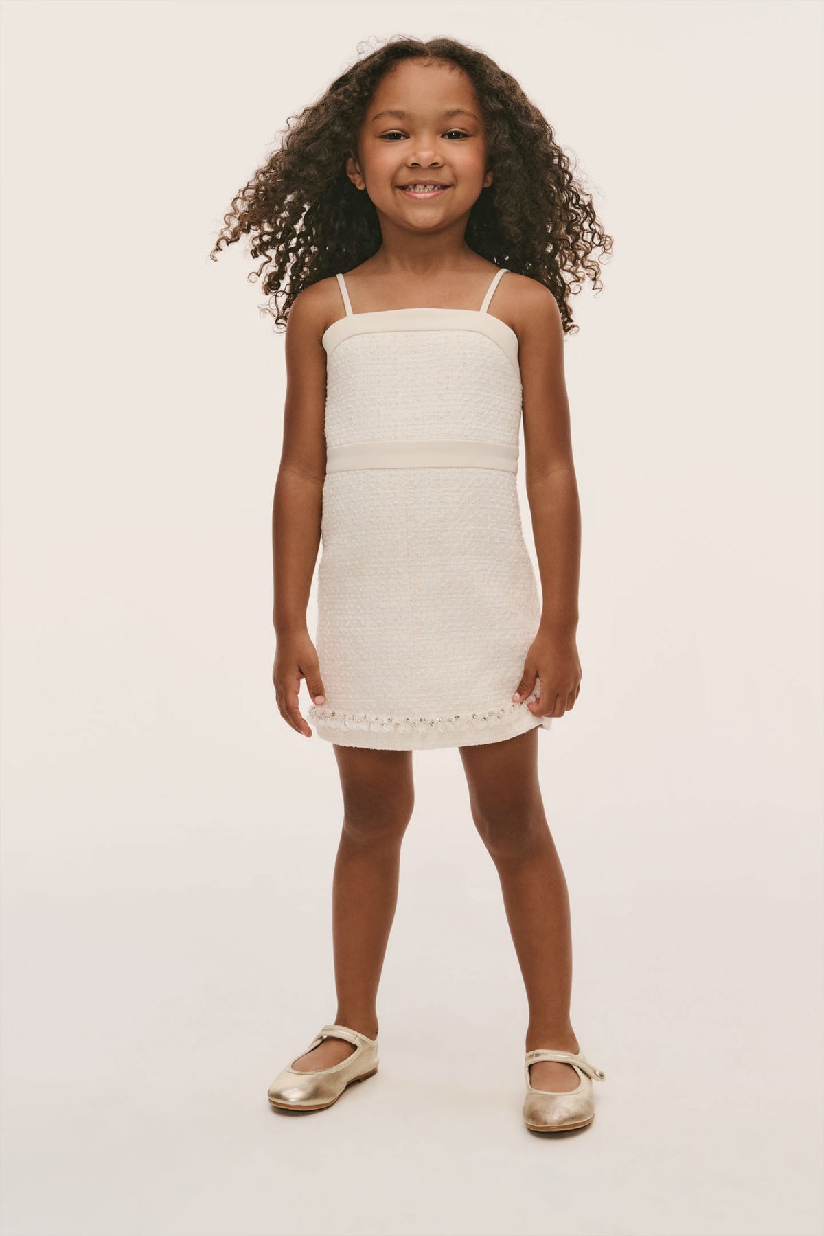 Ivory mini girls dress with spaghetti straps, seam at waist, eyelet-trim hem