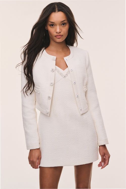 Ivory tweed jacket with button-front, V-neck placket, flap pockets, long sleeves