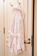 Pink cotton bath robe with shawl collar, tie belt, and all-over floral print