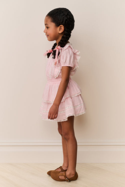 Pink lace-trimmed cotton dress with tiered skirt and short puff sleeves