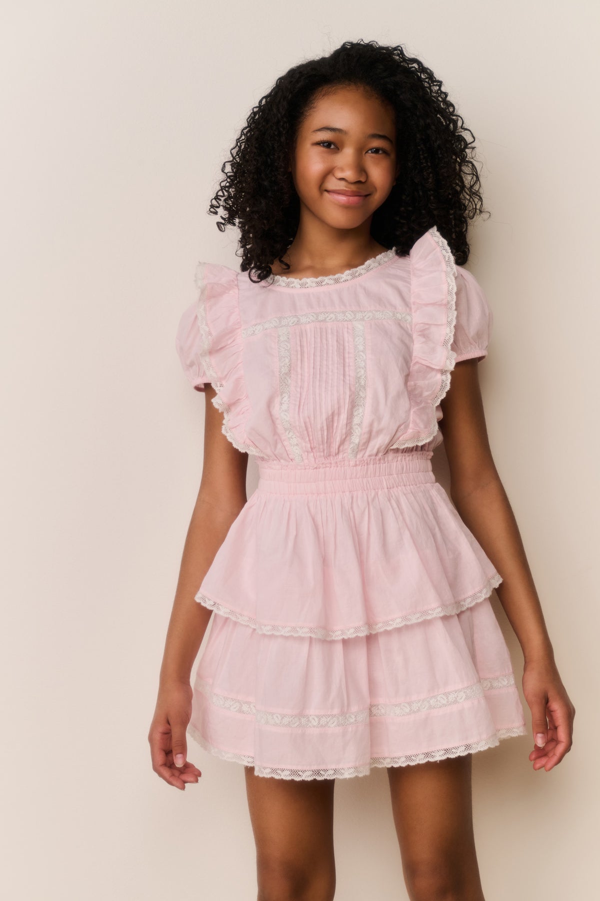 Pink tiered cotton mini dress with puff sleeves and layered ruffle hem