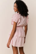 Pink tiered mini cotton dress with puff sleeves and ruffle trim, side view