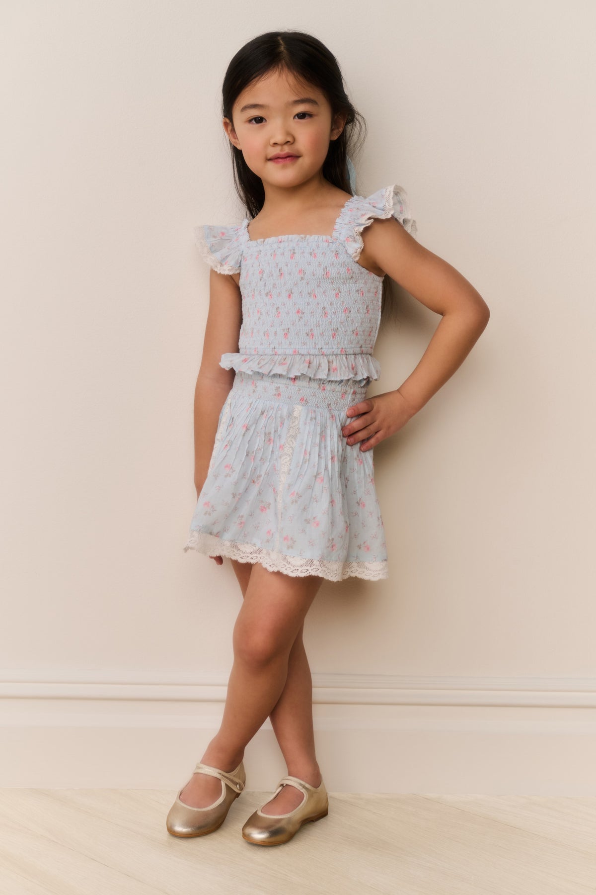 Girls floral cotton mini skirt front view, light ivory with small floral print and ruffled hem