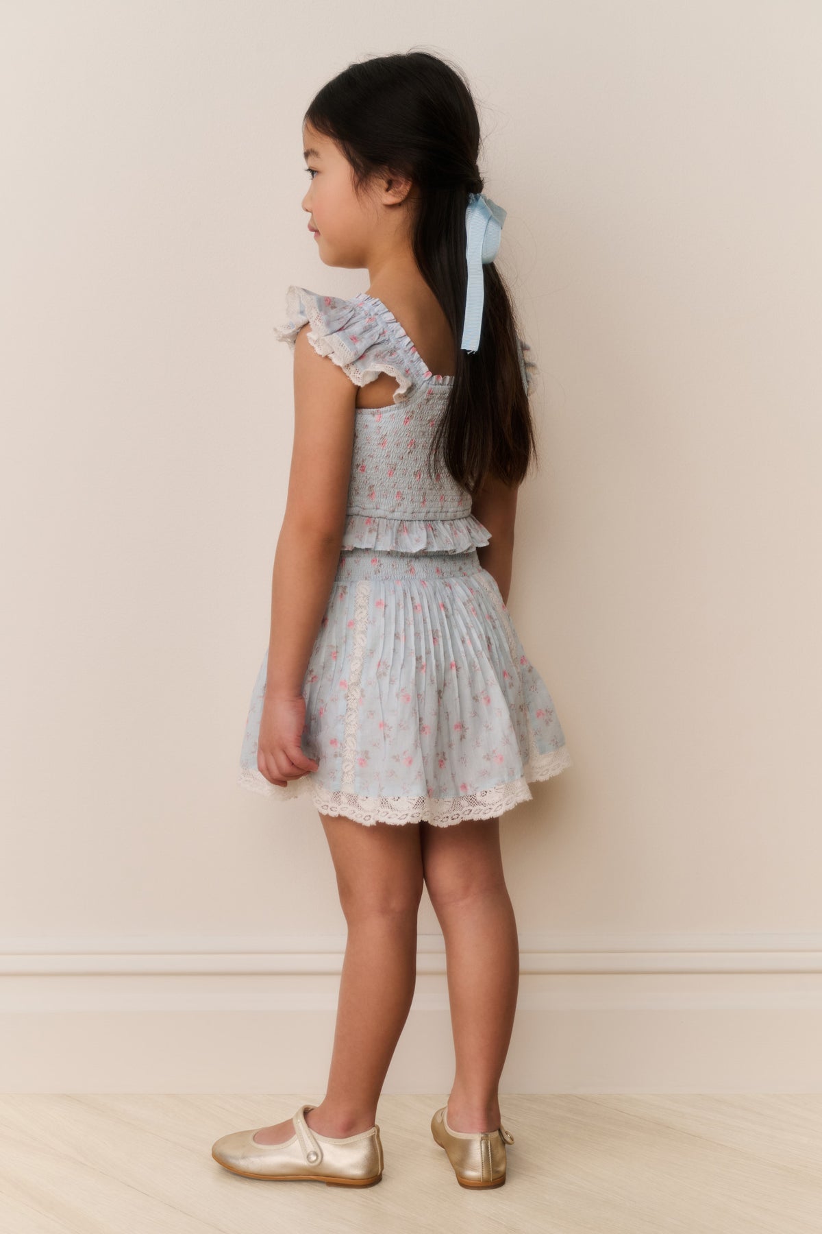 Girls floral cotton mini skirt side view, light ivory with ruffled tiers and gathered waist