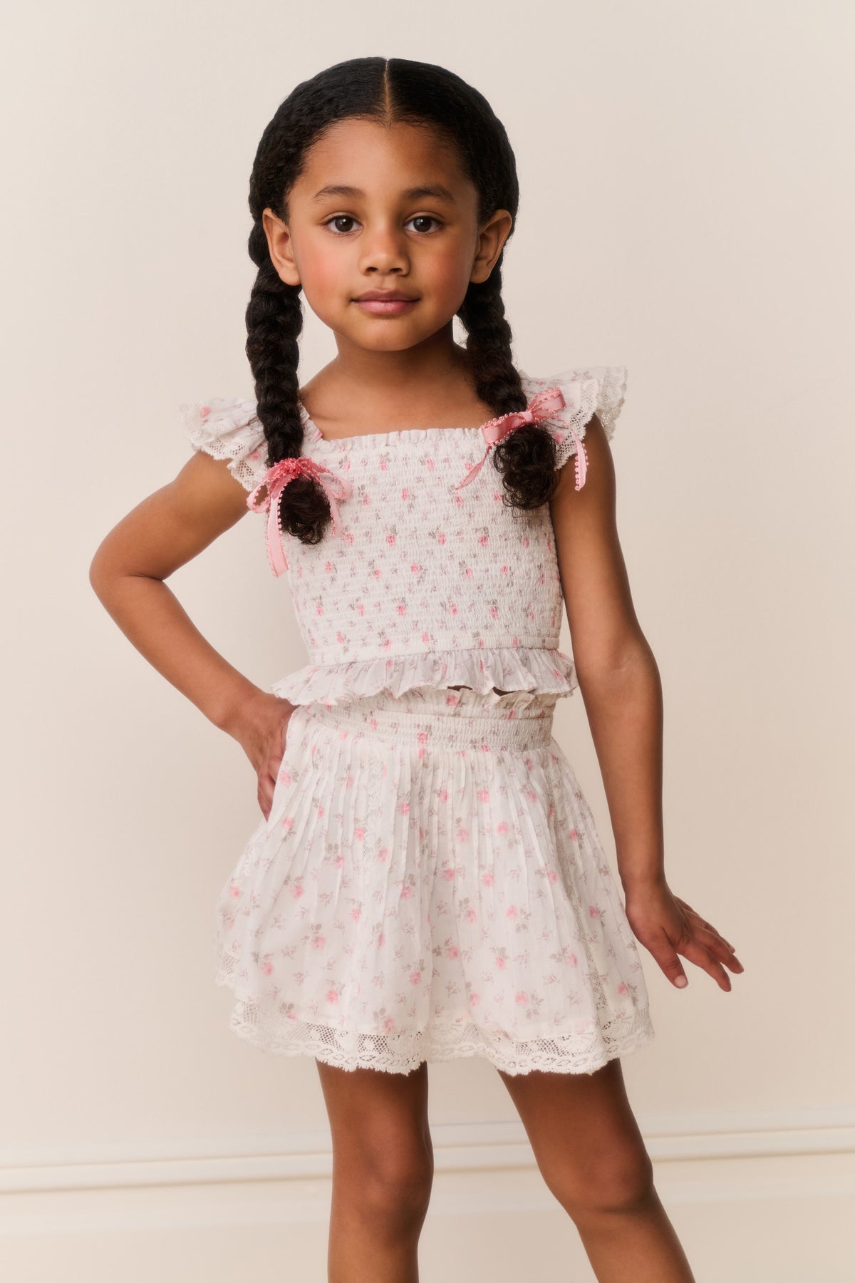 Girls floral cotton mini skirt with elastic waist and lace-like ruffled hem, light ivory