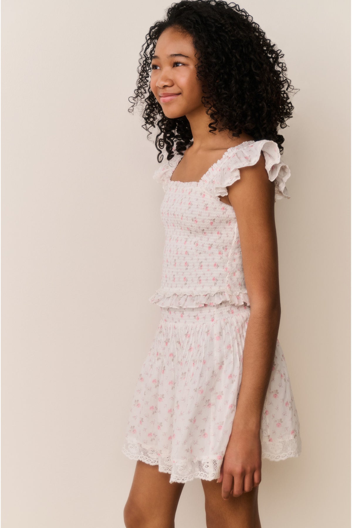 Ivory floral cotton skirt with lace-trim ruffle hem and gathered tiers, side view