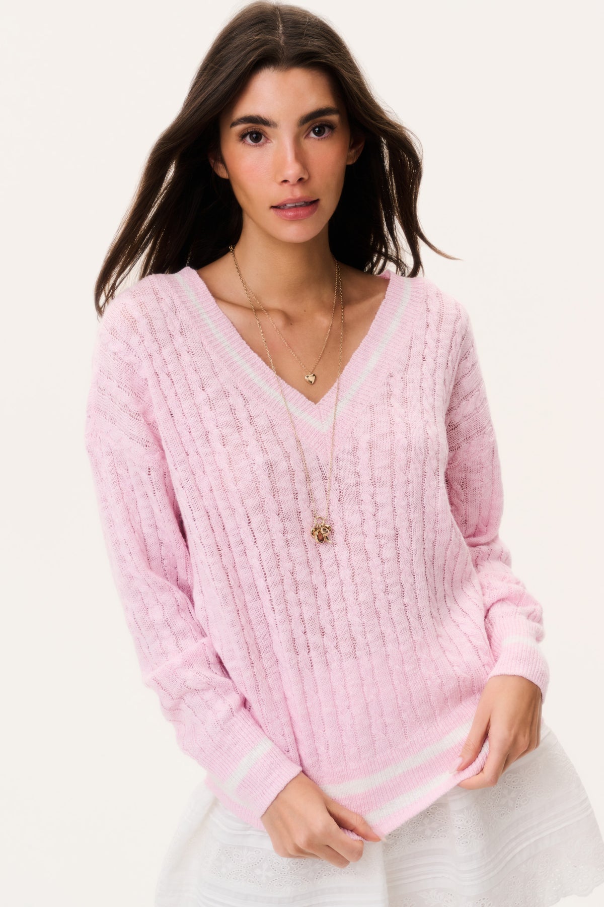 Pink V-neck cable knit pullover with long sleeves and ribbed striped cuffs hem