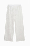 White lace cover-up pants with wide legs, sheer fabric and floral pattern