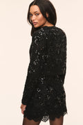 Black embellished cropped jacket, back view with long sleeves and scalloped trim