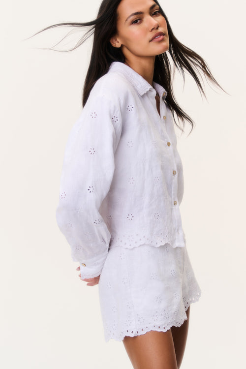 White linen eyelet shorts with scalloped edges and small embroidered eyelet details