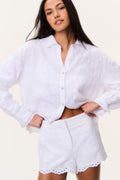 White linen eyelet shorts with scalloped hem and embroidered eyelet pattern