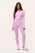 Pink patterned cropped active jacket with full front zipper, worn with matching leggings