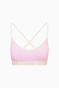 Ditsy floral sports bra with pale base, pink-trim underband and thin crisscross straps